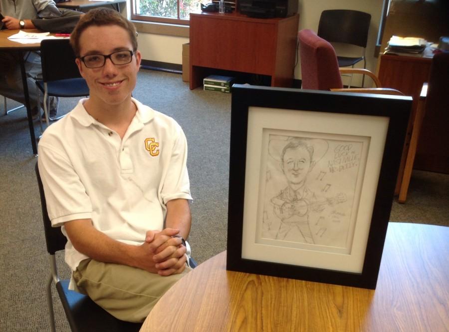 Here, Thomas poses with one of his cartoons 