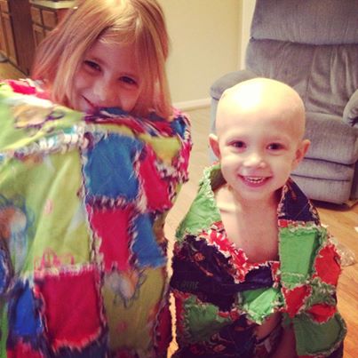 Liam Webb, grandson of CCHS security guard Robert McKeon, poses with his sister as they don handmade blanket capes. Webb passed two years ago of a brain tumor.

