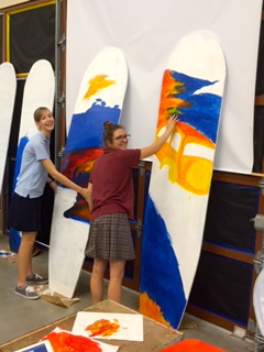 CCHS art students Olivia Staser 16 (right) and Madeleine Moreau 18 display their artistic chops Duke Kahanamoku-style. 