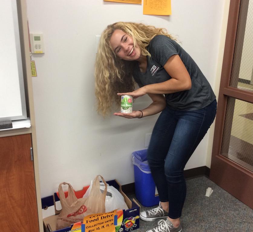 Mary Henderson shows her contribution to the Thanksgiving Food Drive. 