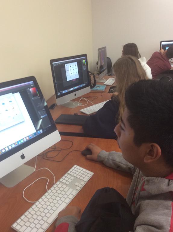 Students work to edit their photos using Adobe Photoshop in photography class. 