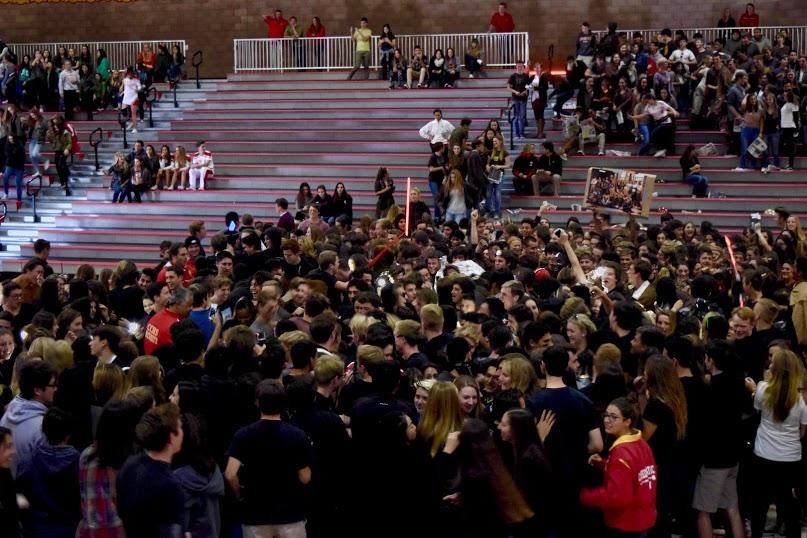 Juniors and seniors rush the gym floor at the “Star Wars” themed rally.