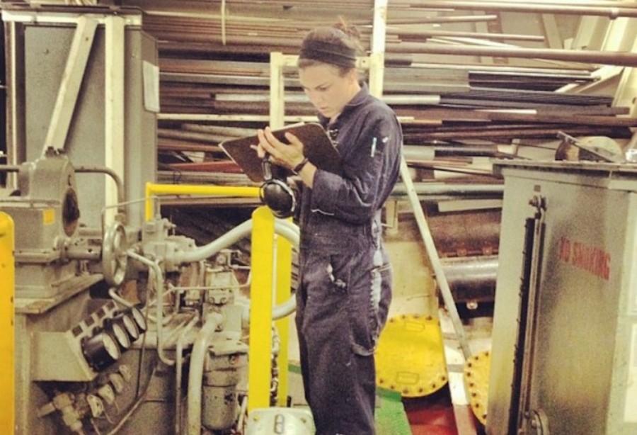 CCHS alumna Sarah McDonald 12 takes readings on the training ship Golden Bears steering gear during one of her training cruises at sea.