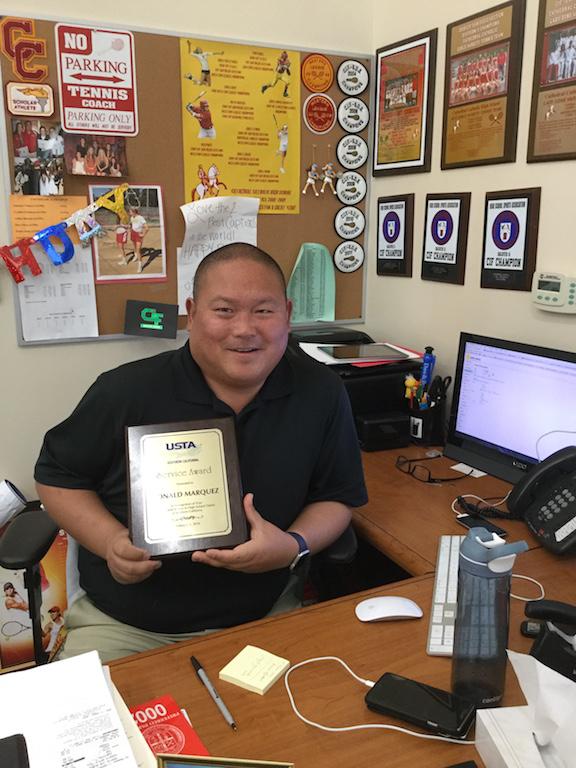 Coach Ron Marquez of the CCHS boys and girls varsity tennis teams brings home a service award from the United States Tennis Association.