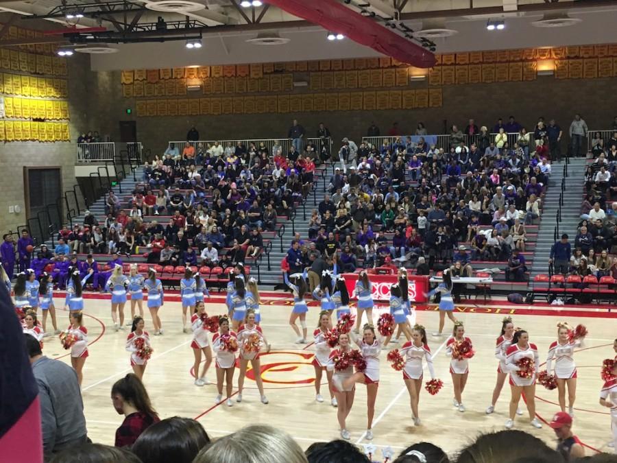 The OLP Pilots cheerleaders and the CCHS Dons cheerleaders meet in the middle of the court to cheer on their respective teams at Friday’s “Holy War” game. 