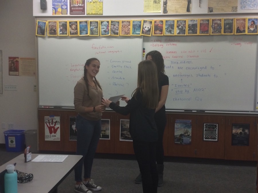El Cid Editor-In-Chief Celine Aubry-Dumand ’16 and Managing Editor Sarah Scherer ’16 congratulate Sports Editor Jackie Heitman ’17 with the El Cid Writer of the Month award. 