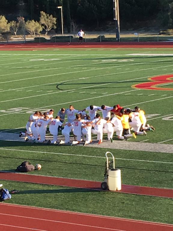 The varsity boys soccer team prays before its first CIF playoff game against Scripps Ranch High School. CCHS won 2-1, and the team will play Torrey Pines High School on Wednesday March 2 at 5:00 p.m.