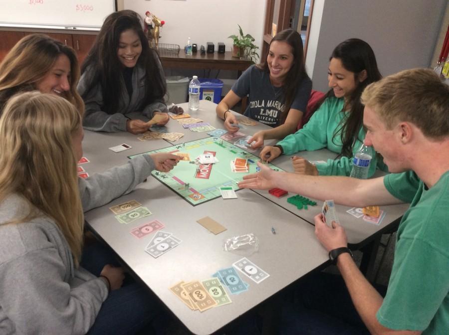 Service Campus Ministers (from left to right) Ashley Knepler ‘16, Jennifer Bumbaugh ‘16, Nicole Naguit ‘16, Haley Heffron ‘16, Nicole Tabarez ‘16, and Dylan Brenk ‘16 demonstrate the effects of economic inequality through the game of rigged monopoly in Campus Ministry.