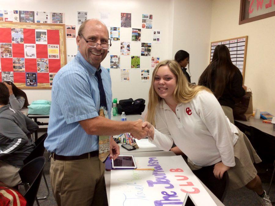 El Cid Student Newspapers Managing Editor for the 2016-2017 school year, Sydney Calhoun 17, accepts a congratulatory welcome into the editor position by advisor, Chris Grazier. 
