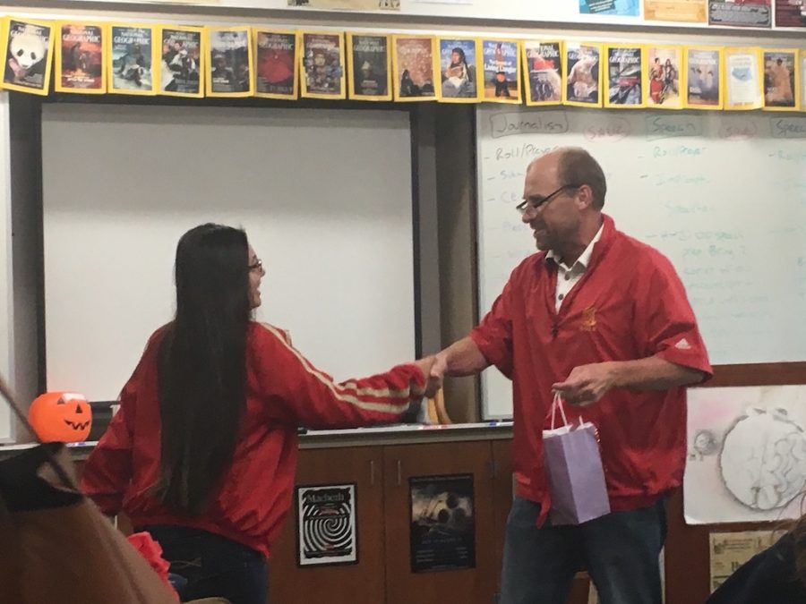 Julia Way ‘16 receives a senior gift from Mr. Grazier in one of her last El Cid classes of the year. 
