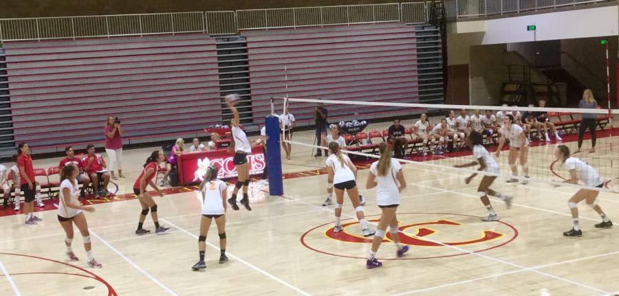 The Lady Dons varsity volleyball team spikes the ball across the net for a 3-1 victory against Del Norte High School.