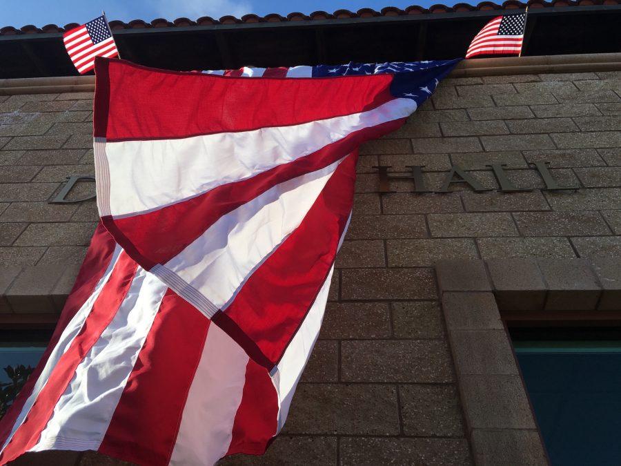 Red, white, and blue flies over Drexel Hall.