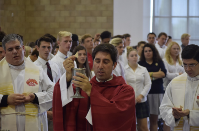 Fr. Martin raises the blood of Christ during the All Saints Day Liturgy on Nov. 1. 