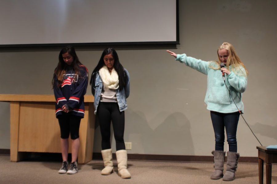 Senior retreat leader Sarah Lackey ‘17 prays over Hailey Nagma ‘17 and Danielle Rizzo ‘17 as they prepare to deliver testimonials in front of the junior girls attending the March Junior Retreat in Julian.