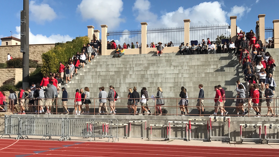 Students walk down the steps of Manchester Stadium after an emergency earthquake drill, preparing for the unpredictable fault line of Southern California.