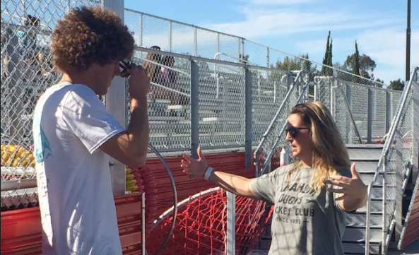 New CCHS swim Head Coach Ms. Colette Reid speaks to assistant coach Troy Marcikic before beginning practice.  The passionate head coach always makes sure everyone in on the same page and ready for a good practice.