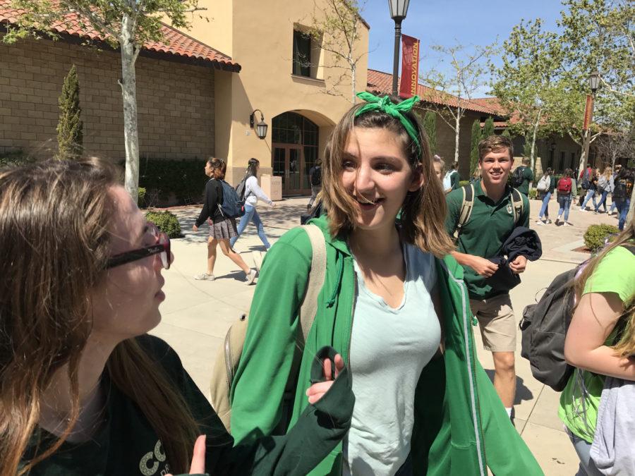 Ava Yung 17 and Alexa Gilbert 17 walk to their gold 6 classes together donning St. Patricks Day attire.