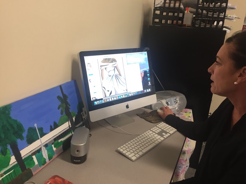 CCHS English teacher and El Sol magazine adviser Mrs. Laurie Allari surveys the new El Sol magazine, which includes art, poetry, photography, and short stories. Many students use the magazine as a way to express themselves.