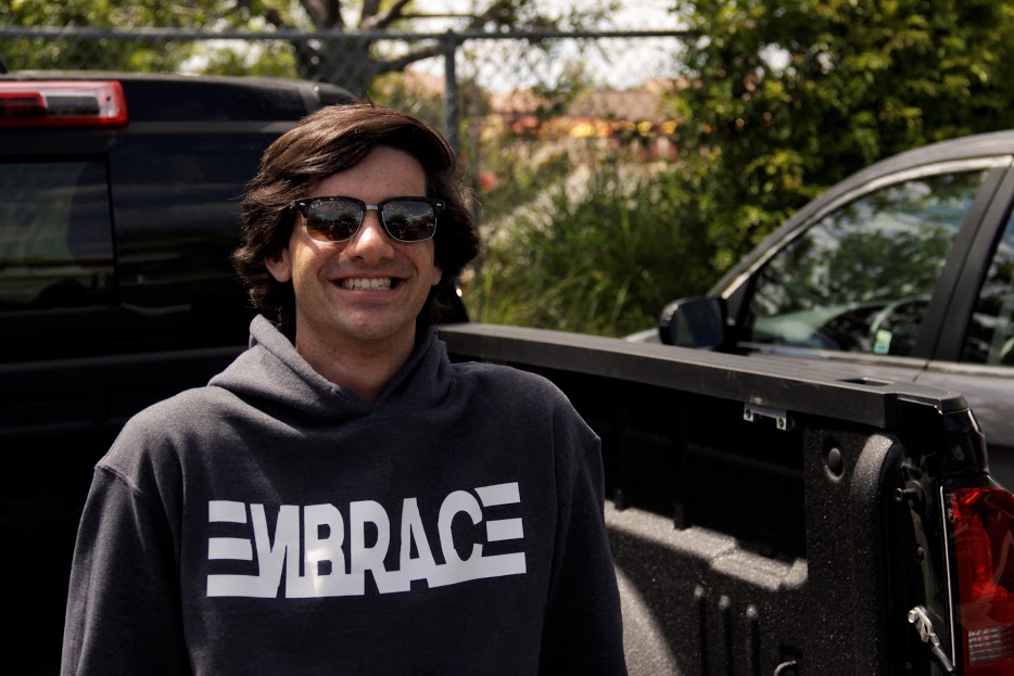 Andrew Dow ‘17 poses wearing his newly created clothing line, a project of his new company Embrace. 
