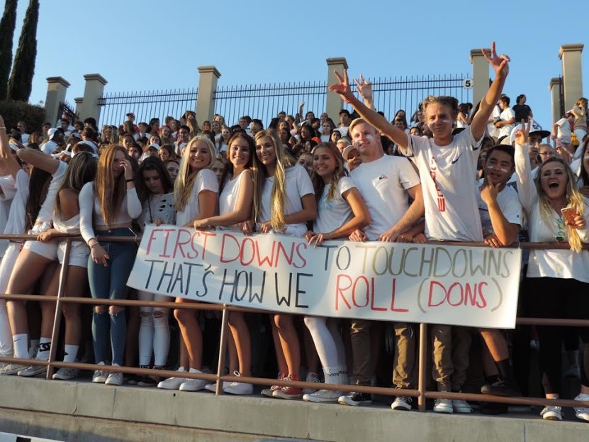 The class of 2017 embraces its school spirit, donned in all white, as it cheers for the varsity football team during one of the last home football games of the year.