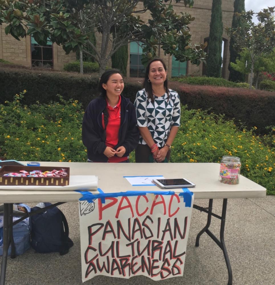 Chemistry teacher Mrs. Viveca Asuncion and Minh Chau 18, leader of the Pan Asian Cultural Awareness Club, share a laugh as they recruit new members during club week.