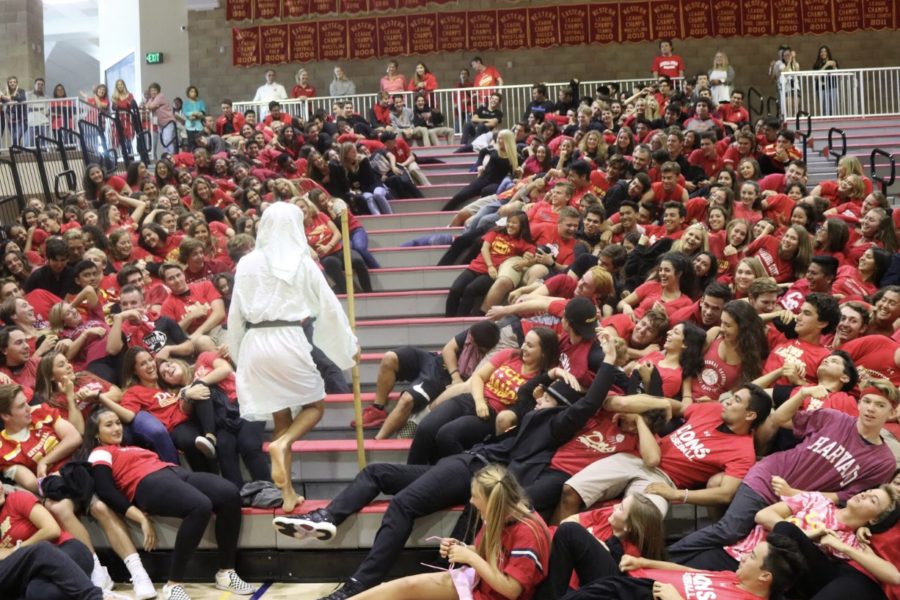 Joaquin Martinez de Pinillos 18 acts as Moses and parts the Red Sea of seniors at Fridays homecoming rally.