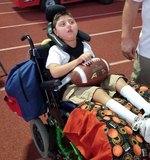 Michael Santon, who was adopted recently by the CCHS football team, watches on the sideline during the recent CCHS vs. Orange Lutheran High School football game at Manchester Stadium. 



