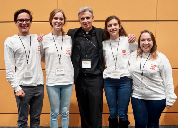 CCHS students Johnny Teixeira 18’, Emily Smedley 18’, Ceci Bacich 20’, and CCHS math teacher Ms. Christine LaPorte pose with Bishop Thomas Daly, one of the speakers at the Cornerstone Catholic Conference.
