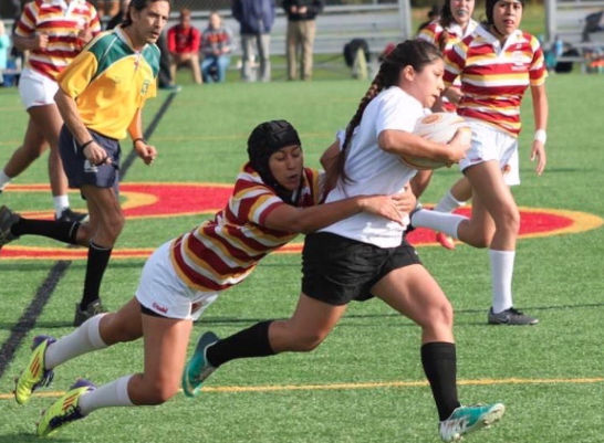 Captain Kaelene Walter ‘19 tackles a forward during a girls rugby game last season. 
