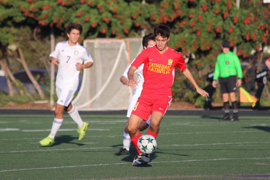 Co-captain and striker Andrew Kleszewski dribbles away from a Saint Augustine High School player.