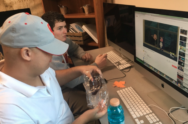 CCHS students Johnathan Montgomery ’19 and Junior Mihas ’21 enjoy their lunch together while watching some of Mihas’ favorite videos. 
