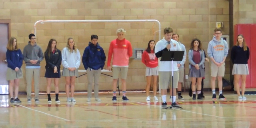 The United Student Leadership Council leads an all-school prayer service Wednesday in the Claver Center to honor the 17 lives lost during the recent shooting in Parkland, Florida, offering up prayers for the victims and families from Marjory Stoneman Douglas High School.