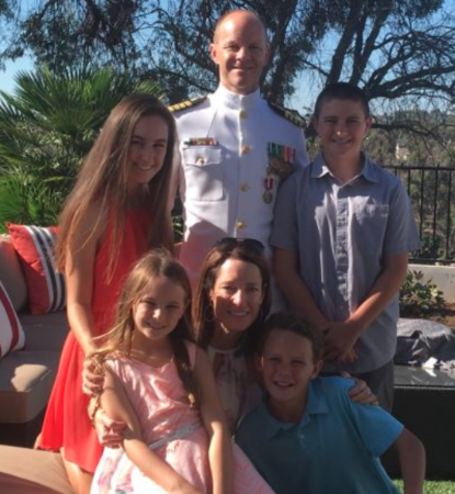 Dr. Brian Fitzgerald stands in his Navy whites among his four kids and wife at their home during time spent back in San Diego after deployment. 

