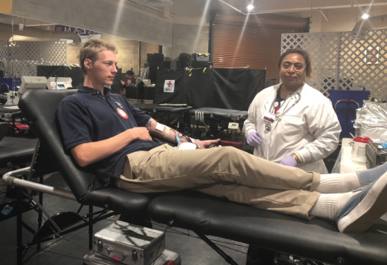 CCHS student Max Beyer '18 (left) relaxes as a blood technician draws blood from him during the school's annual blood drive yesterday hosted by the Red Cross Club. Maintaining San Diego's blood supply is critical to the recovery of cancer patients and auto accident victims.