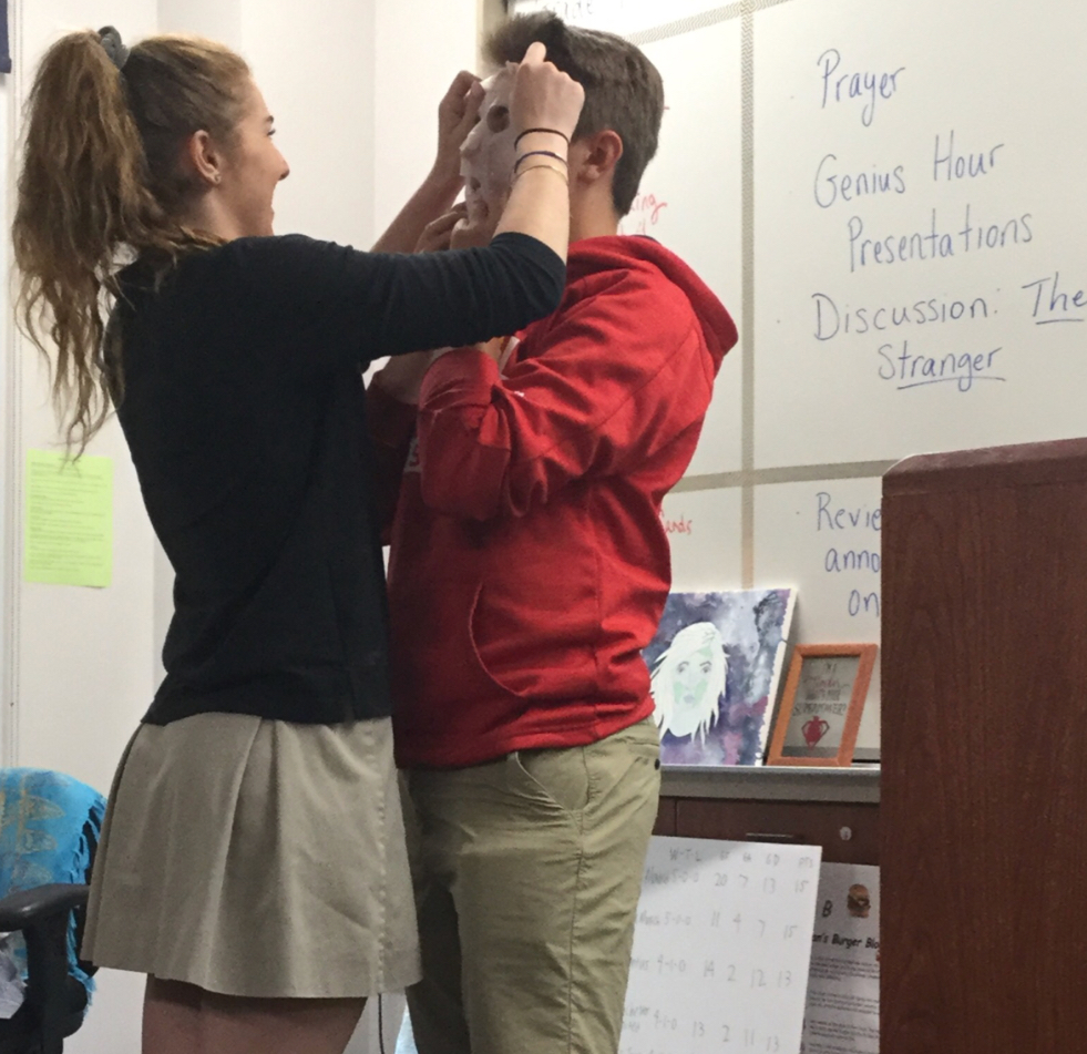 In order to teach her classmates easy ways to reduce stress, Mia Miele '20 places a face mask on Kevin Lopatka '20 after her class presentation Tuesday regarding self-care during Mrs. Jenelle Roberge's English 2 Honors class.
