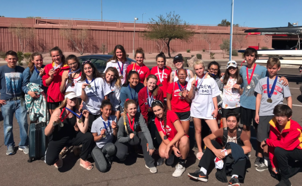 Members of the Cathedral Catholic High School varsity crew team display their medals after the team’s most recent competition. 