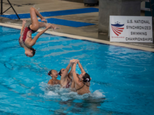 Alexandra Suarez ‘18 and her team, the Santa Clara Aquamaids, perform a lift at the 2018 U.S. Junior National Synchronized Swimming Championships in Lewisville, Texas, where the team won gold.
