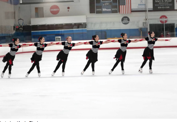 Remy Reeb ‘20 (second from the right) and her team members perform the wheel element during their annual 2018 showcase at the San Diego Ice Arena. 
