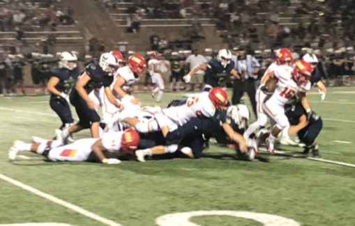 Running back Shawn Poma ‘19 breaks away from tacklers for a large gain in the fourth quarter of last Friday's season opener at La Costa Canyon High School.
