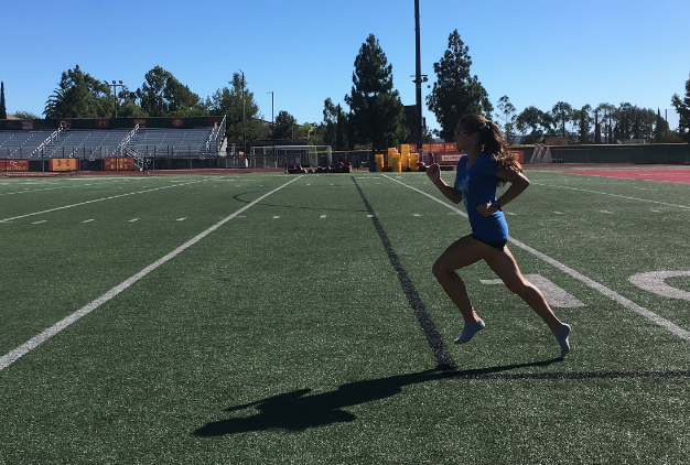 After a four-mile run, varsity cross country runner Marilyn Hobrock 20 performs sprinting strides to improve the quality and endurance of her form during longer races. 