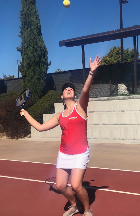 Junior varsity tennis player Kylie Knepler 20 practices her serve, hoping to gain strength and skill as she prepares to dominate Thursday against Scripps Ranch High School. 