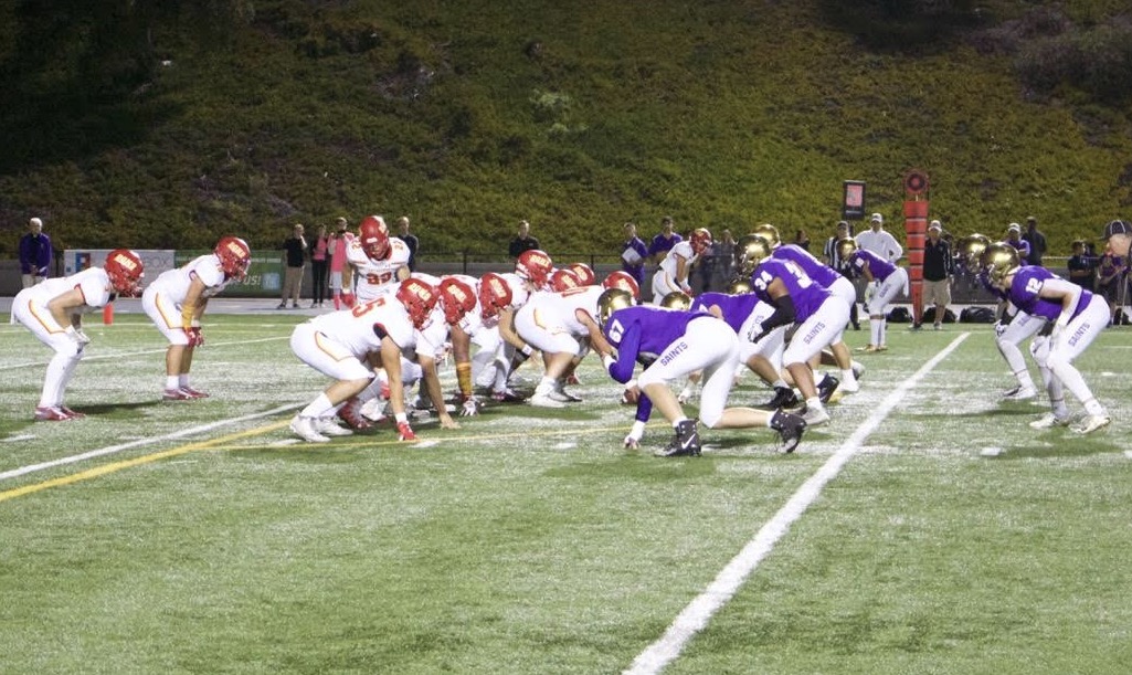 As quarterback DJ Ralph ‘20 prepares to take control of the ball, both the SAHS Saints and CCHS Dons line up to begin a play during last night’s Holy Bowl, where the Dons eventually took home a 34-17 victory.