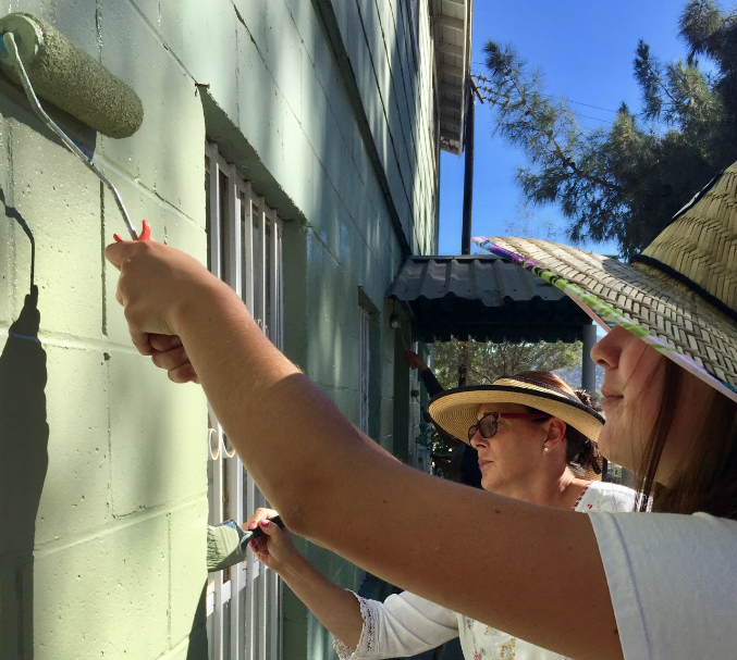 During a trip to Texans, Mexico, junior Delaney Fritz ‘20, right, and her mother Kathryn Fritz, left, joined fellow members of the Outreach for Nazareth Orphanage Club on Saturday to help paint the dilapidated wall of a dormitory.
