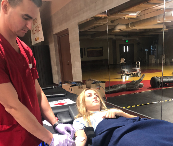 During the CCHS Blood Drive held by the Red Cross Association, Ella Murphy ‘20 calmly lies down as the phlebotomist draws a pint of her blood, which will be donated to local hospitals to help patients in need of a transfusion.
