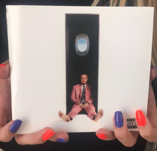 Kenzie Kuras ‘19 holds up a CD copy of the late Mac Miller’s latest album, which received praise from critics, who called it “the most impactful album of his career. Miller’s overdose happened barely a month after the albums release.
