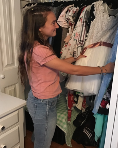 Marie Temprendola ‘19 examines previous homecoming dresses, while searching for neon and white to match this year’s theme.
