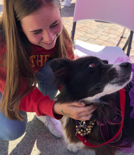 Maddie Hazeltine ‘21 cuddles with Sticky, a trained border collie therapy dog sporting a purple tutu, during Friday’s “Pugs not Drugs” day of Red Ribbon Week. Therapy dogs like Sticky are used as coping mechanisms for people suffering from stress and anxiety instead of turning to drugs and alcohol.

