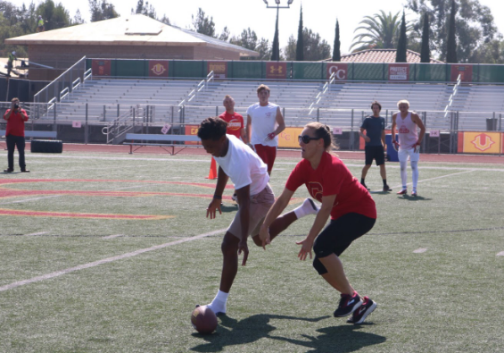 Jalen Dye ‘19 and Mrs. Sara Rhodes compete in the students- teachers freeze football game on Thursday during Red Ribbon Week. The students defeated the teachers 21-7.