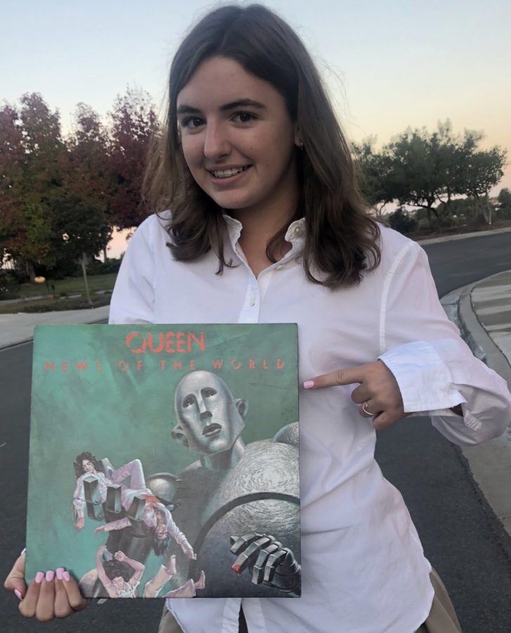 Cathedral Catholic High School student Megan Garvey ‘22 holds a Queen record as she prepares to view the upcoming film, Bohemian Rhapsody, which describes Mr. Freddie Mercury’s life and his journey while leading Queen on its path to fame. 