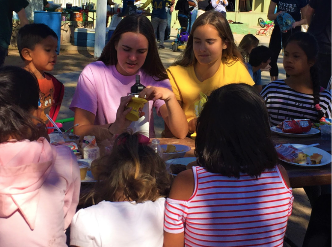 The Outreach for Nazareth Orphanage Club hosted its second trip to an orphanage in Tecate,Mexico on Saturday. During the trip, club members Delaney Fritz ‘20, left, and Emma Caringella ‘20, right, painted faded picnic tables and entertained the orphanage children during lunch break.